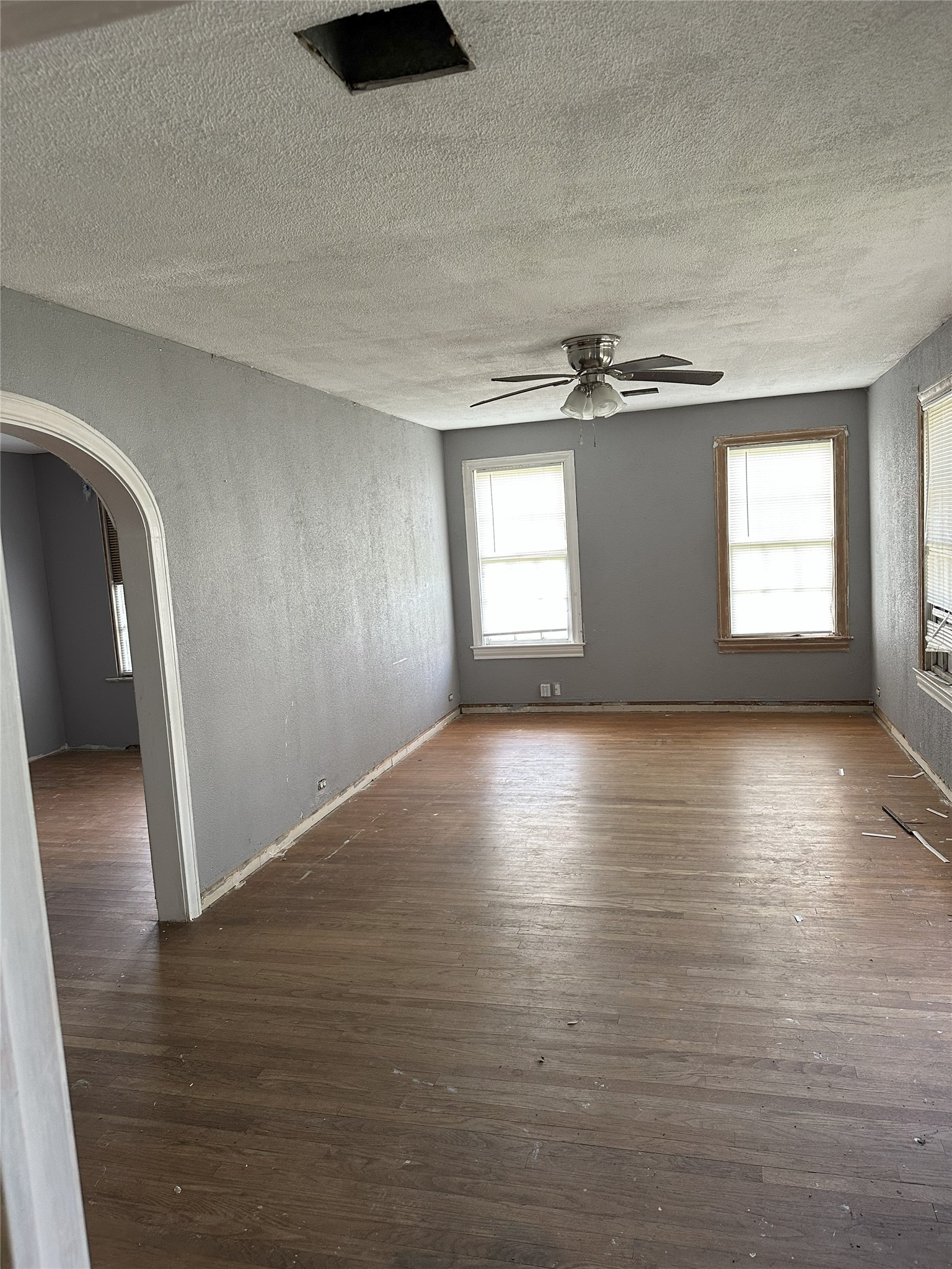 1108 MacArthur Street Rosenberg, TX 77471 - Photo 2 of 9 wooden floor in an empty room with a window