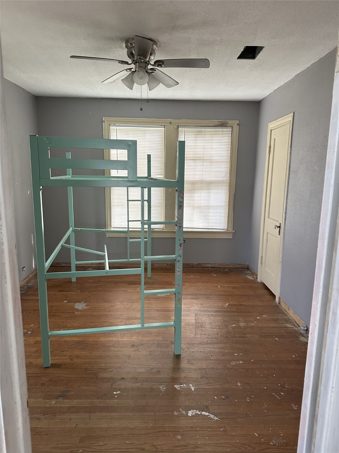 1108 MacArthur Street Rosenberg, TX 77471 - Photo 3 of 9 a view of empty room with wooden floor and fan
