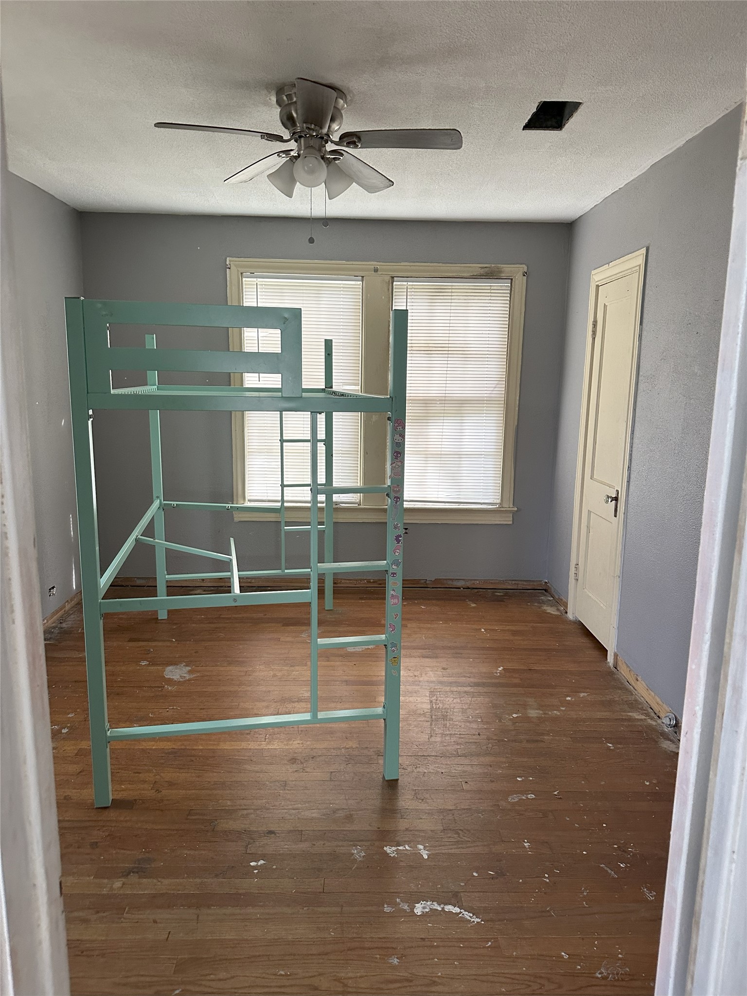 1108 MacArthur Street Rosenberg, TX 77471 - Photo 3 of 9 a view of empty room with wooden floor and fan