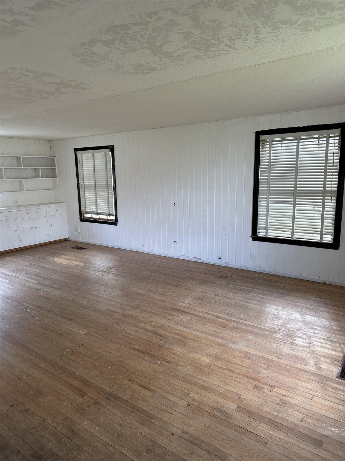 1108 MacArthur Street Rosenberg, TX 77471 - Photo 7 of 9 an empty room with wooden floor and windows