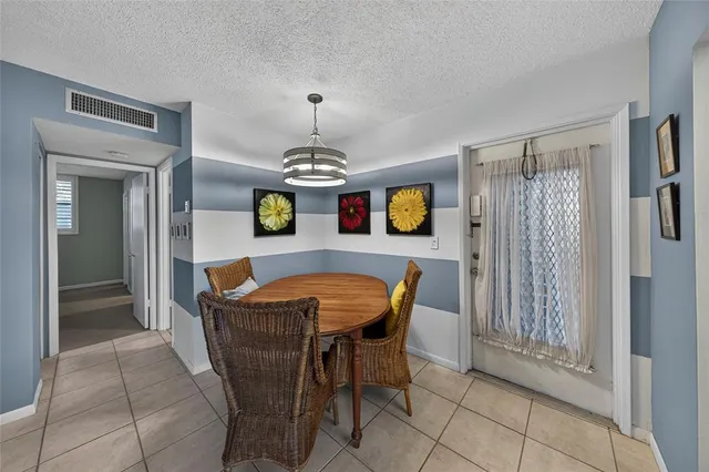 a dining room with furniture and chandelier