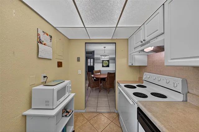 a utility room with cabinets dryer and washer