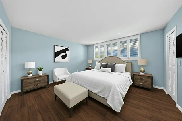 a bedroom with a bed and a large window