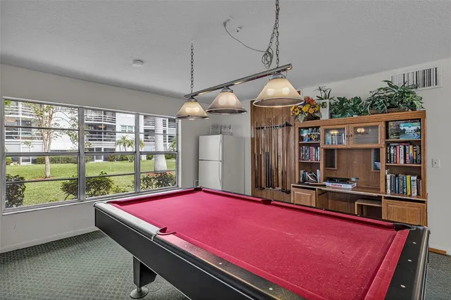 a living room with furniture a air conditioner vent and a window