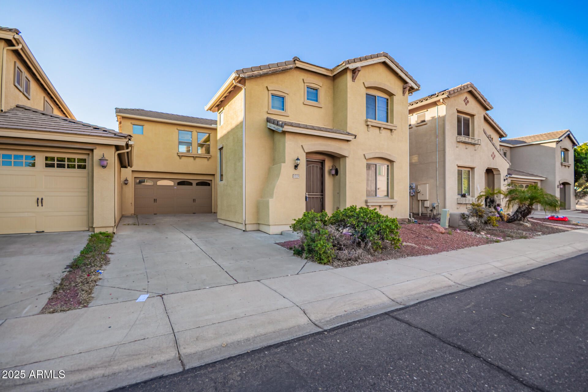 15170 North 145th Lane Surprise, AZ 85379 - Photo 4 of 40 a front view of a house with a yard and a garage