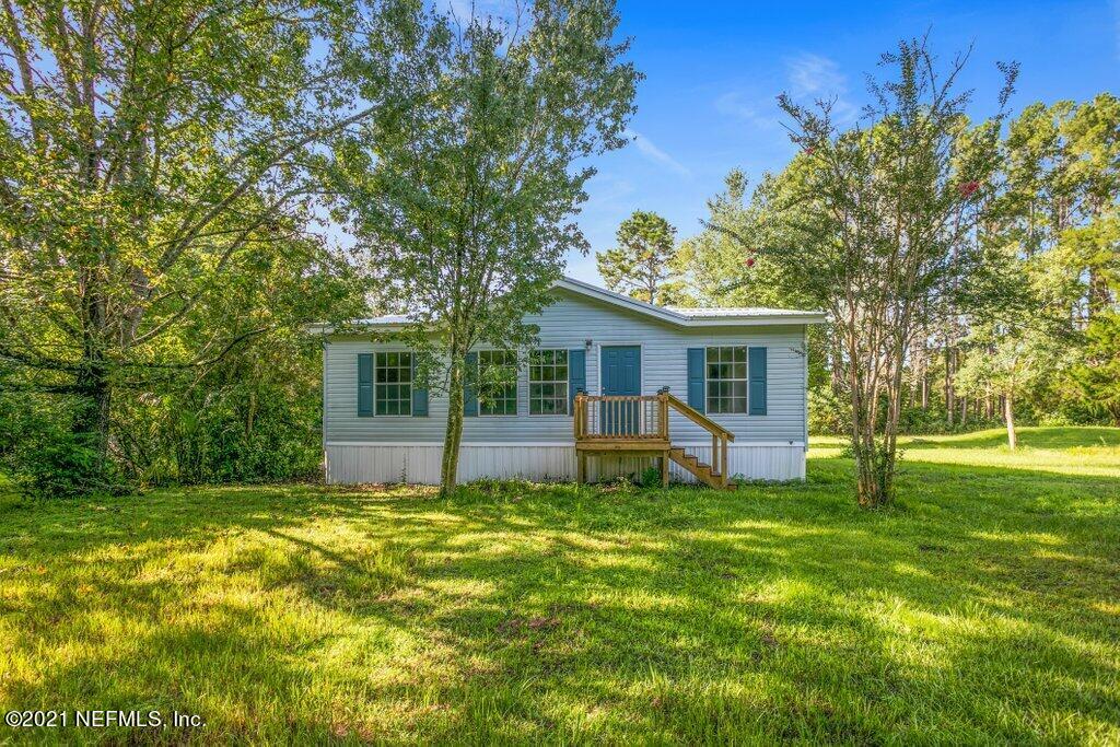 54162 Heron Road Callahan, FL 32011 - Photo 1 of 32 a view of a house with a big yard and a large tree
