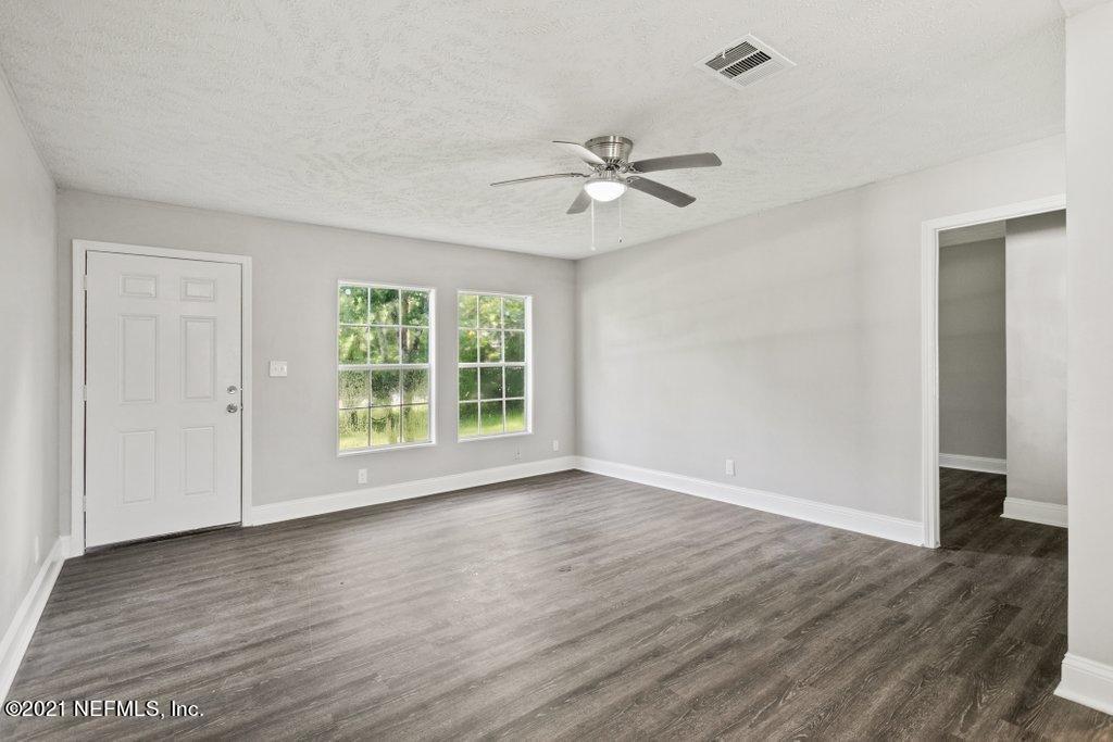 54162 Heron Road Callahan, FL 32011 - Photo 8 of 32 a view of empty room with wooden floor and fan