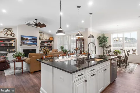 a kitchen with stainless steel appliances a sink stove and cabinets