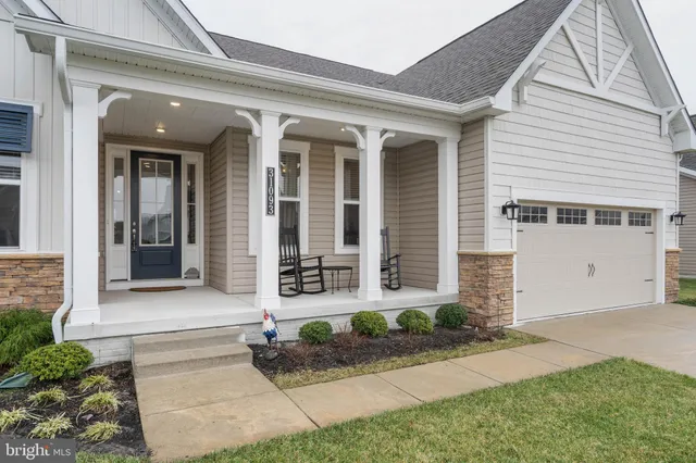 a view of a patio with table and chairs potted plants and large tree
