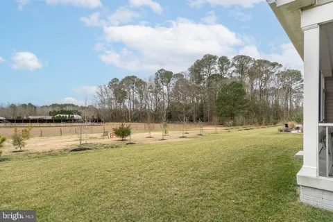 a kitchen with kitchen island granite countertop wooden floors stainless steel appliances a sink and a counter space