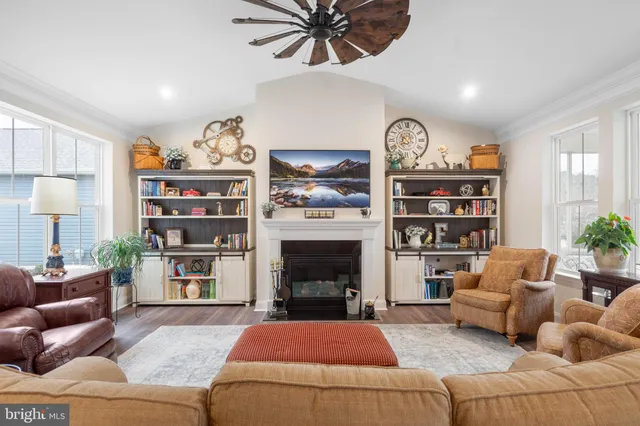a living room with furniture a fireplace and a flat screen tv