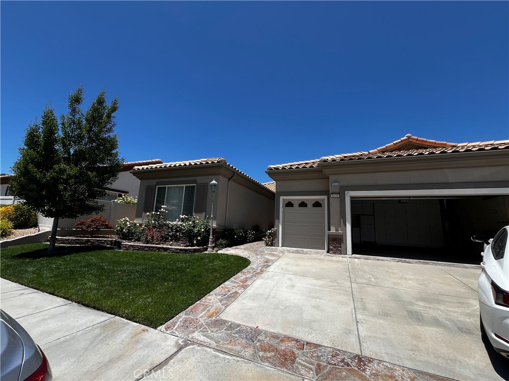 5233 Hampton Road Banning, CA 92220 - Photo 1 of 1 a front view of a house with a yard and garage
