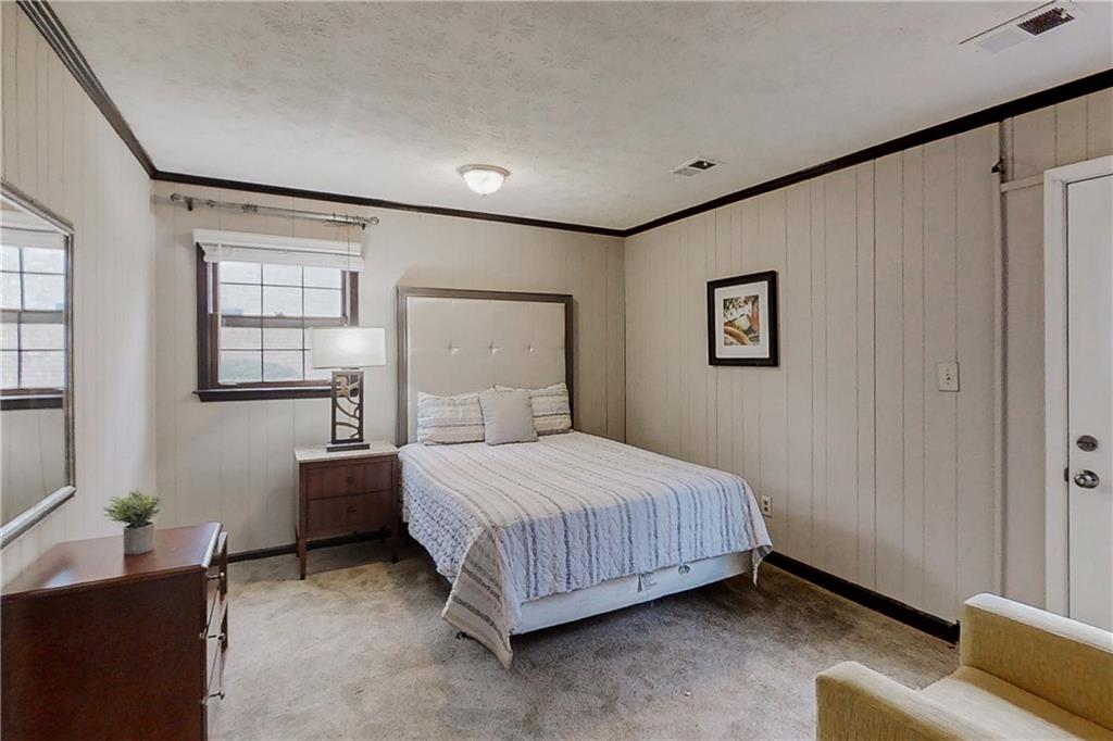 2284 Emerald Springs Drive Decatur, GA 30035 - Photo 23 of 30 a bedroom with a bed and a night stand