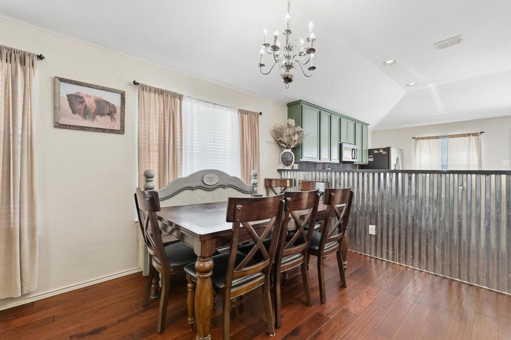 1201 Roping Reins Way Fort Worth, TX 76052 - Photo 11 of 34 a view of a dining room with furniture and wooden floor