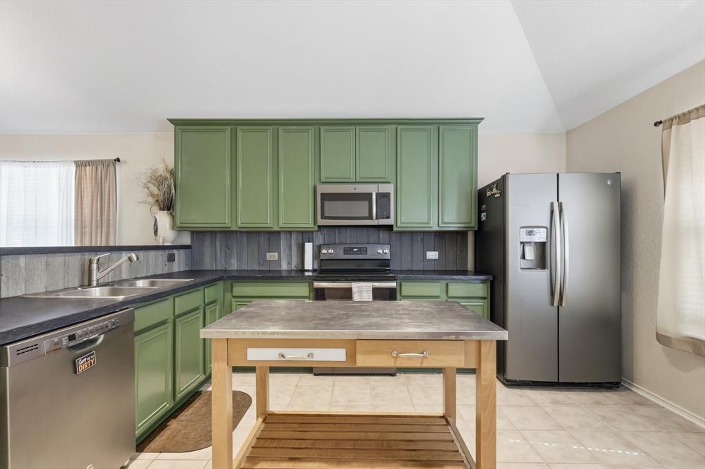 1201 Roping Reins Way Fort Worth, TX 76052 - Photo 17 of 34 a kitchen with a refrigerator sink and microwave