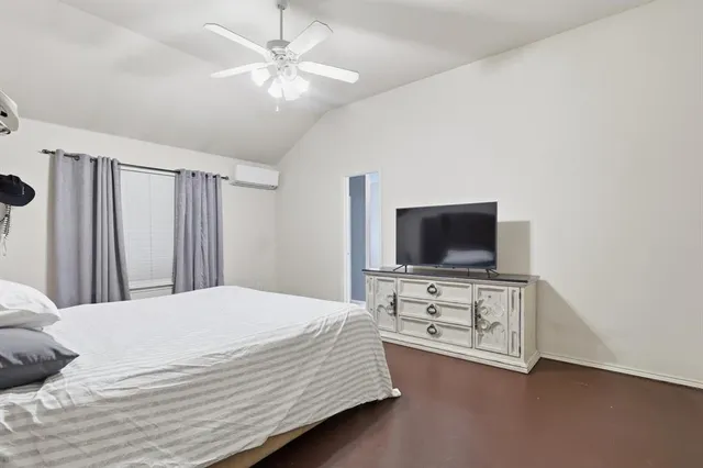 a bedroom with a bed and a flat screen tv