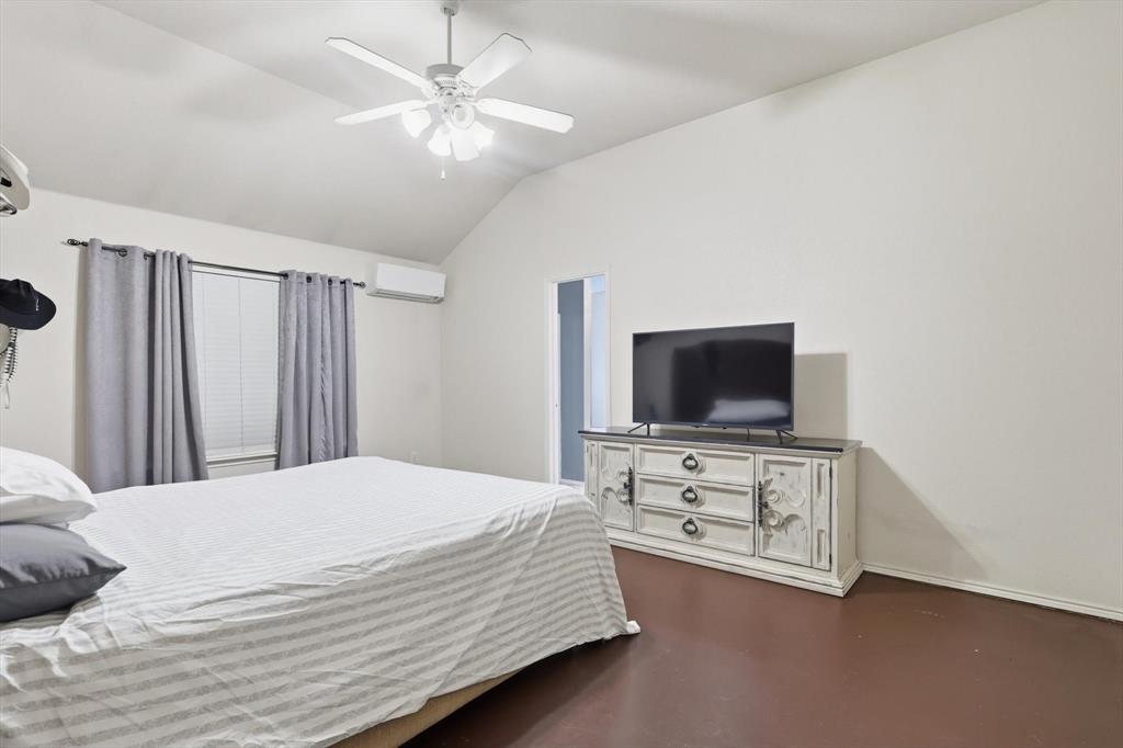 1201 Roping Reins Way Fort Worth, TX 76052 - Photo 18 of 34 a bedroom with a bed and a flat screen tv