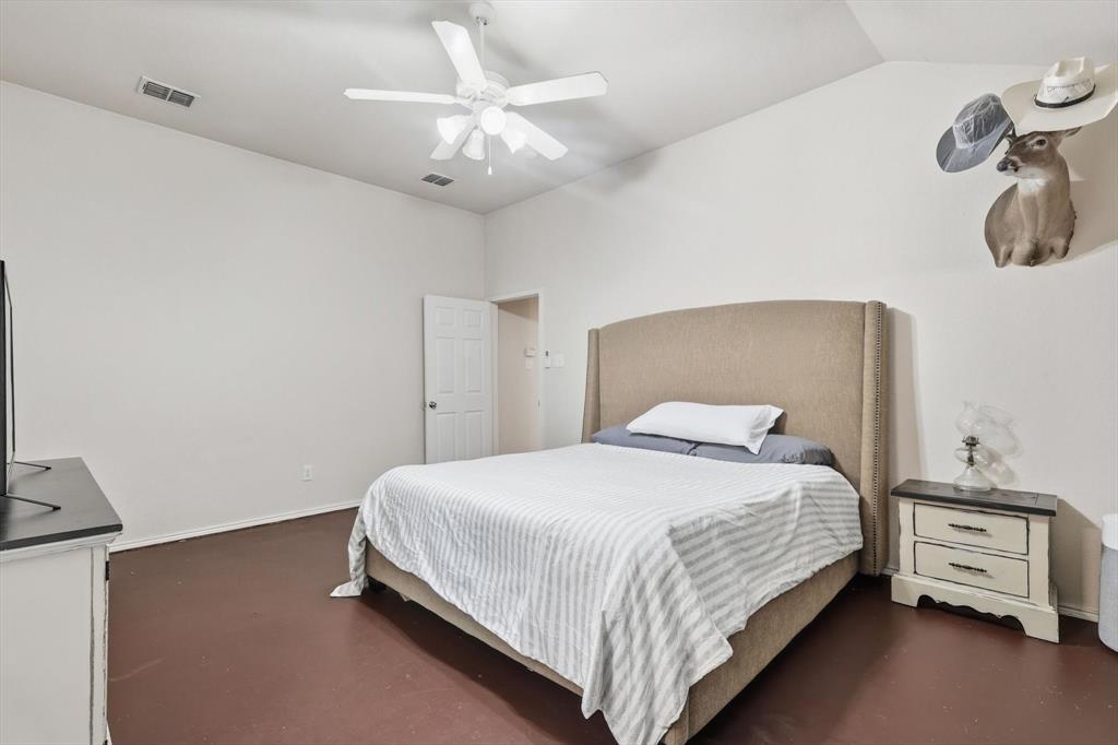 1201 Roping Reins Way Fort Worth, TX 76052 - Photo 19 of 34 a bedroom with a bed and a chandelier