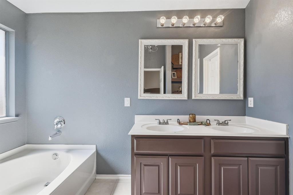 1201 Roping Reins Way Fort Worth, TX 76052 - Photo 20 of 34 a bathroom with a sink and a bathtub