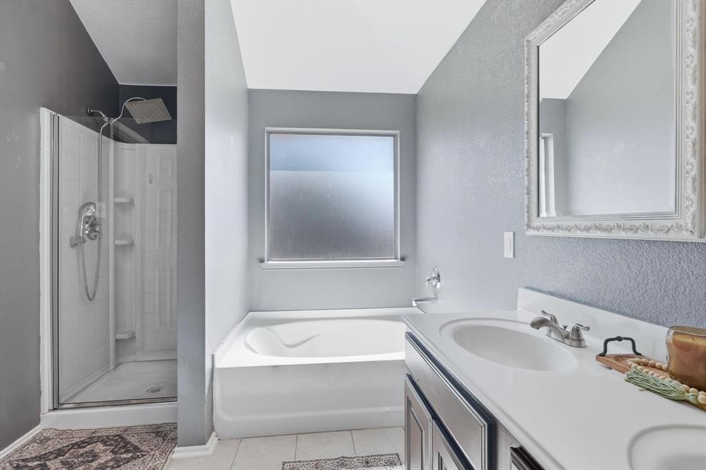1201 Roping Reins Way Fort Worth, TX 76052 - Photo 21 of 34 a bathroom with a tub sink shower and mirror