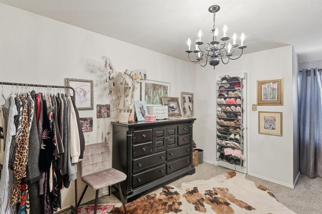1201 Roping Reins Way Fort Worth, TX 76052 - Photo 24 of 34 a view of a bedroom with furniture window and wooden floor