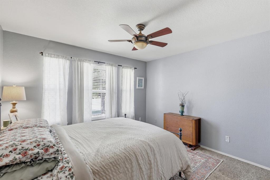 1201 Roping Reins Way Fort Worth, TX 76052 - Photo 27 of 34 a bedroom with a bed and a window