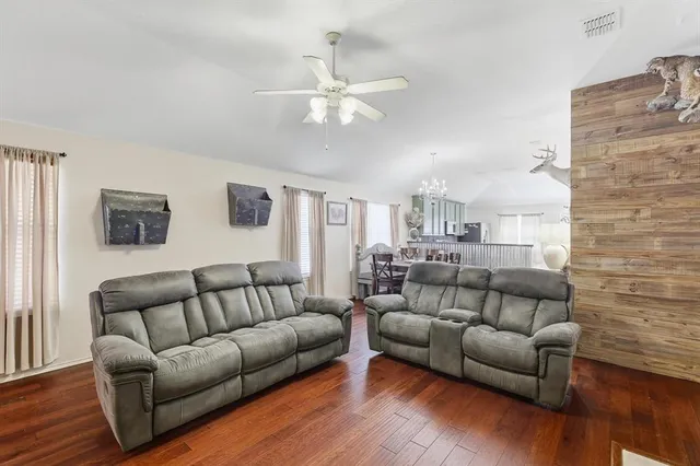 a living room with furniture and wooden floor