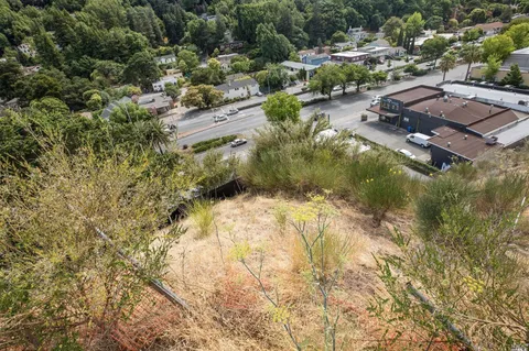 an aerial view of residential house with swimming pool and green space