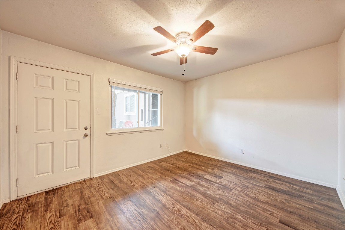 1106 West 22nd Street, Unit 9 Austin, TX 78705 - Photo 9 of 11 wooden floor in an empty room with a window