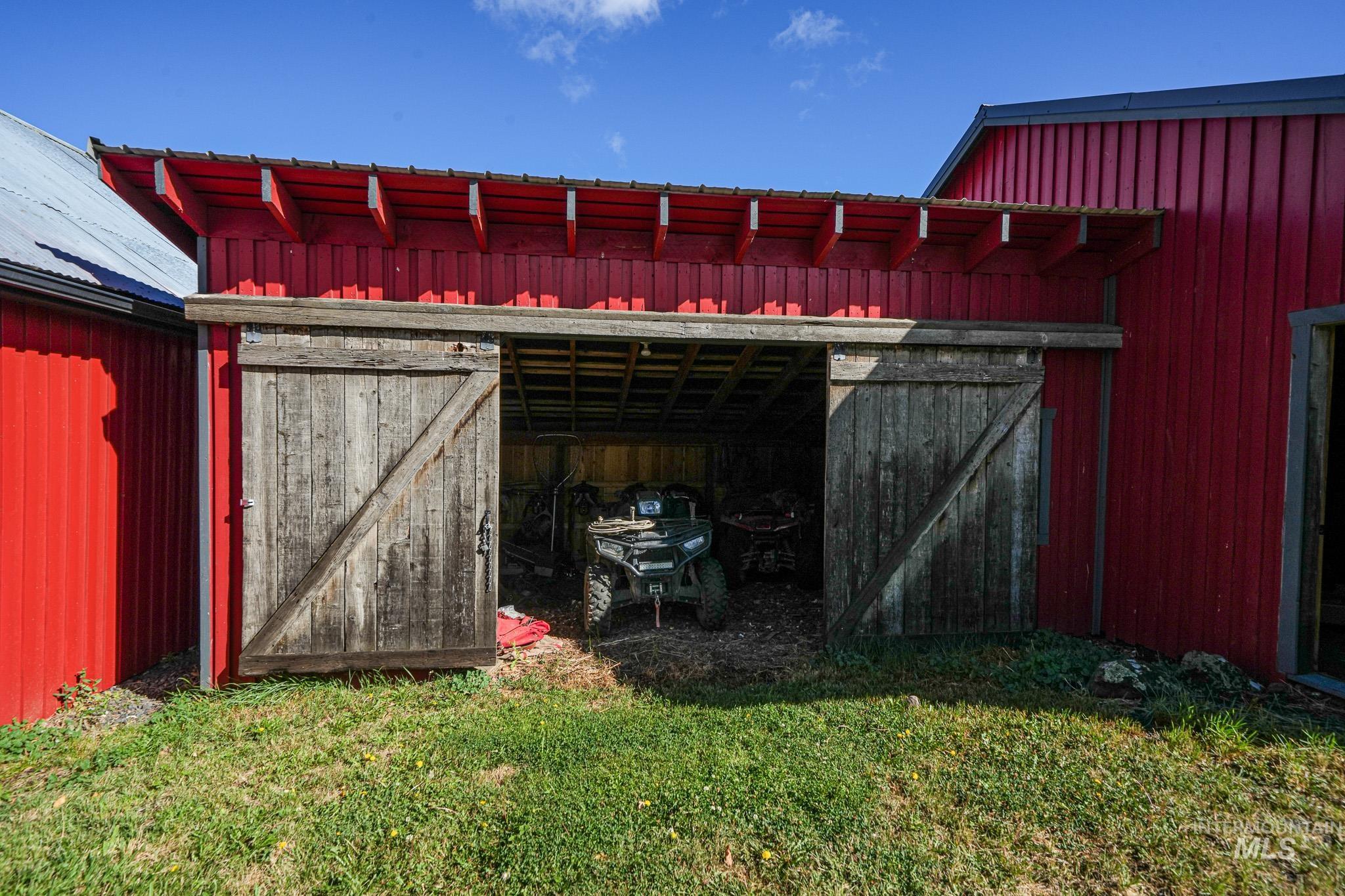 67 Jessup Road Grangeville, ID 83530 - Photo 23 of 49 Red board-and-batten siding with a corrugated metal roof