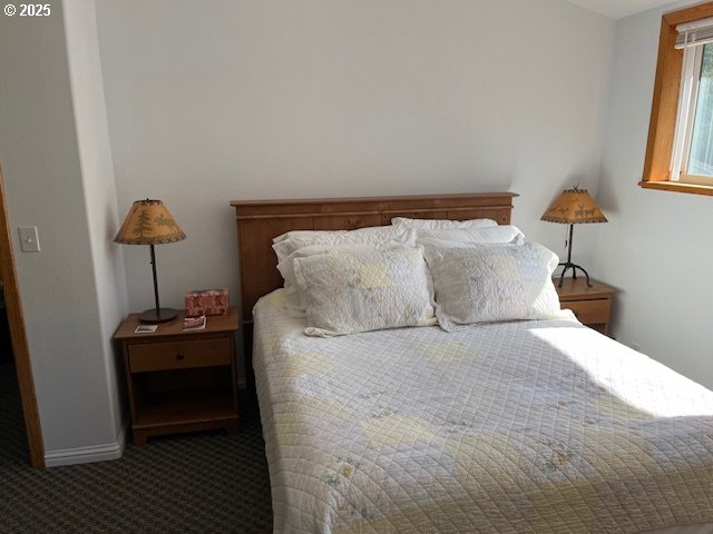 78544 Rat Creek Road Cottage Grove, OR 97424 - Photo 26 of 44 a bedroom with a bed and a table