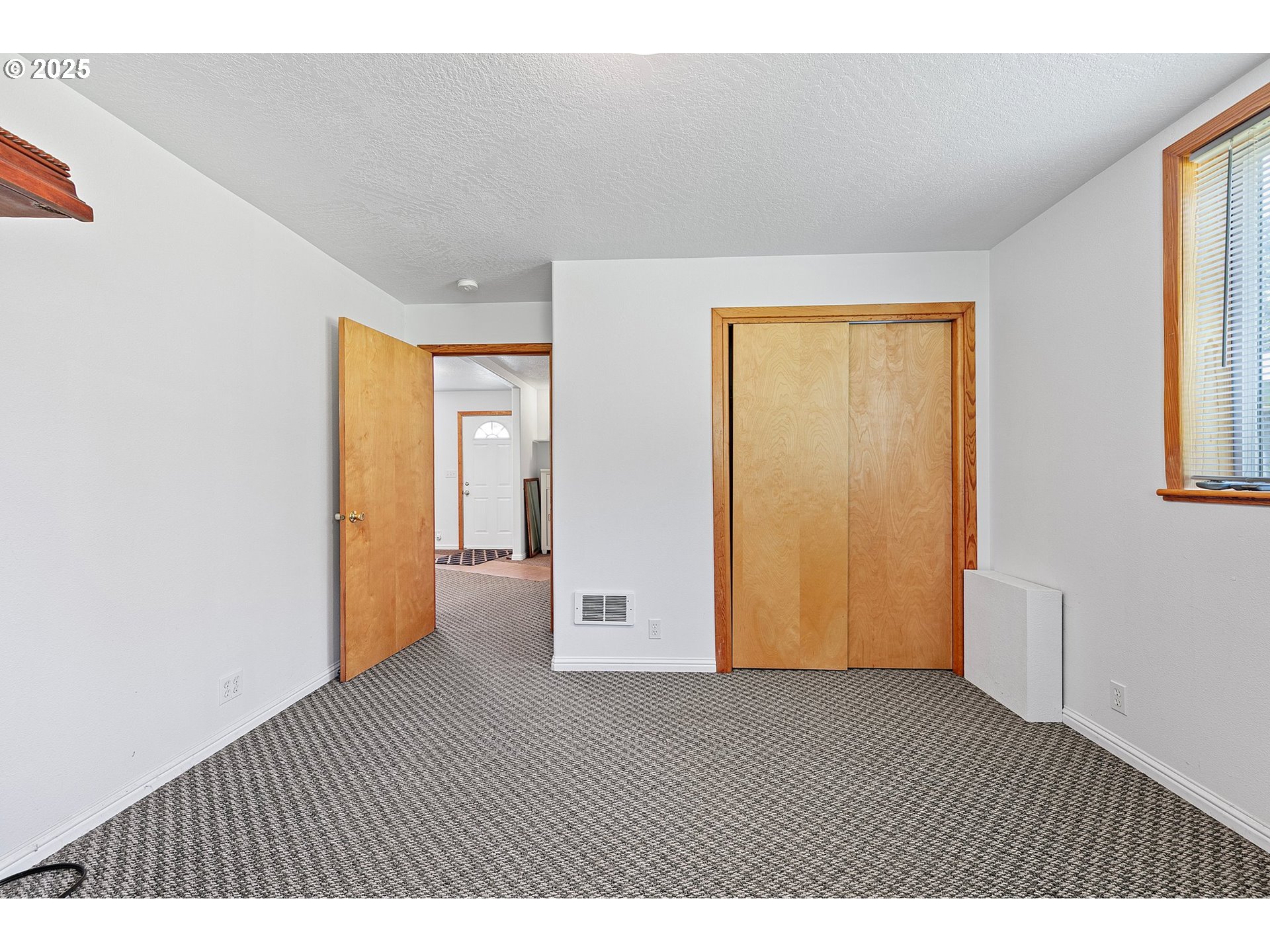 78544 Rat Creek Road Cottage Grove, OR 97424 - Photo 32 of 44 a view of an empty room with wooden floor and a window