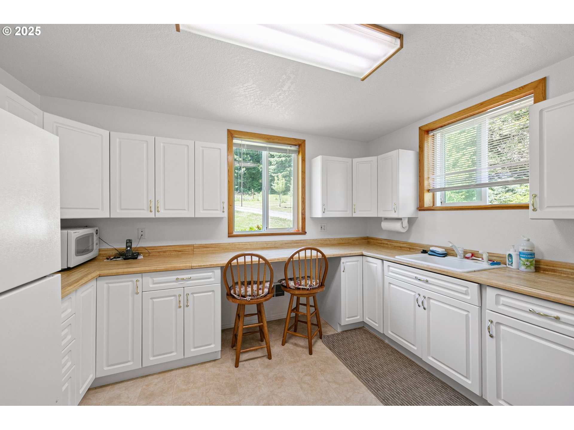 78544 Rat Creek Road Cottage Grove, OR 97424 - Photo 33 of 44 a kitchen with a sink cabinets and window