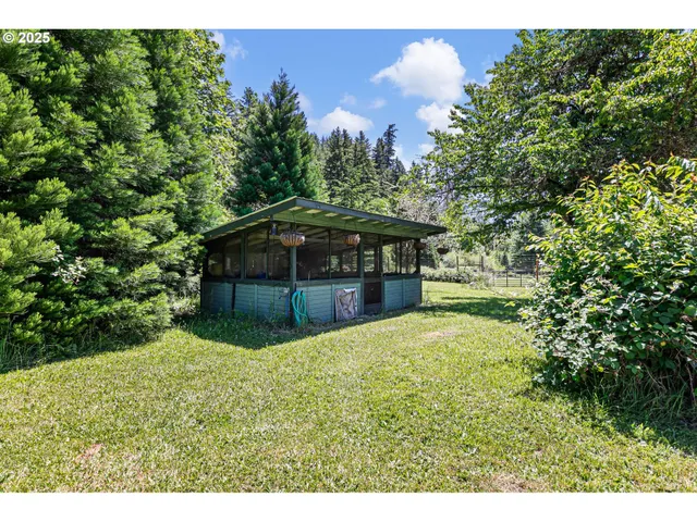 a backyard of a house with table and chairs