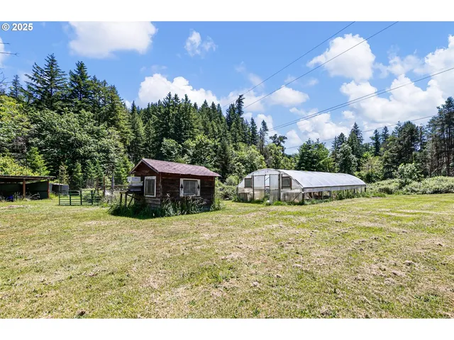 an aerial view of a house with swimming pool and outdoor seating