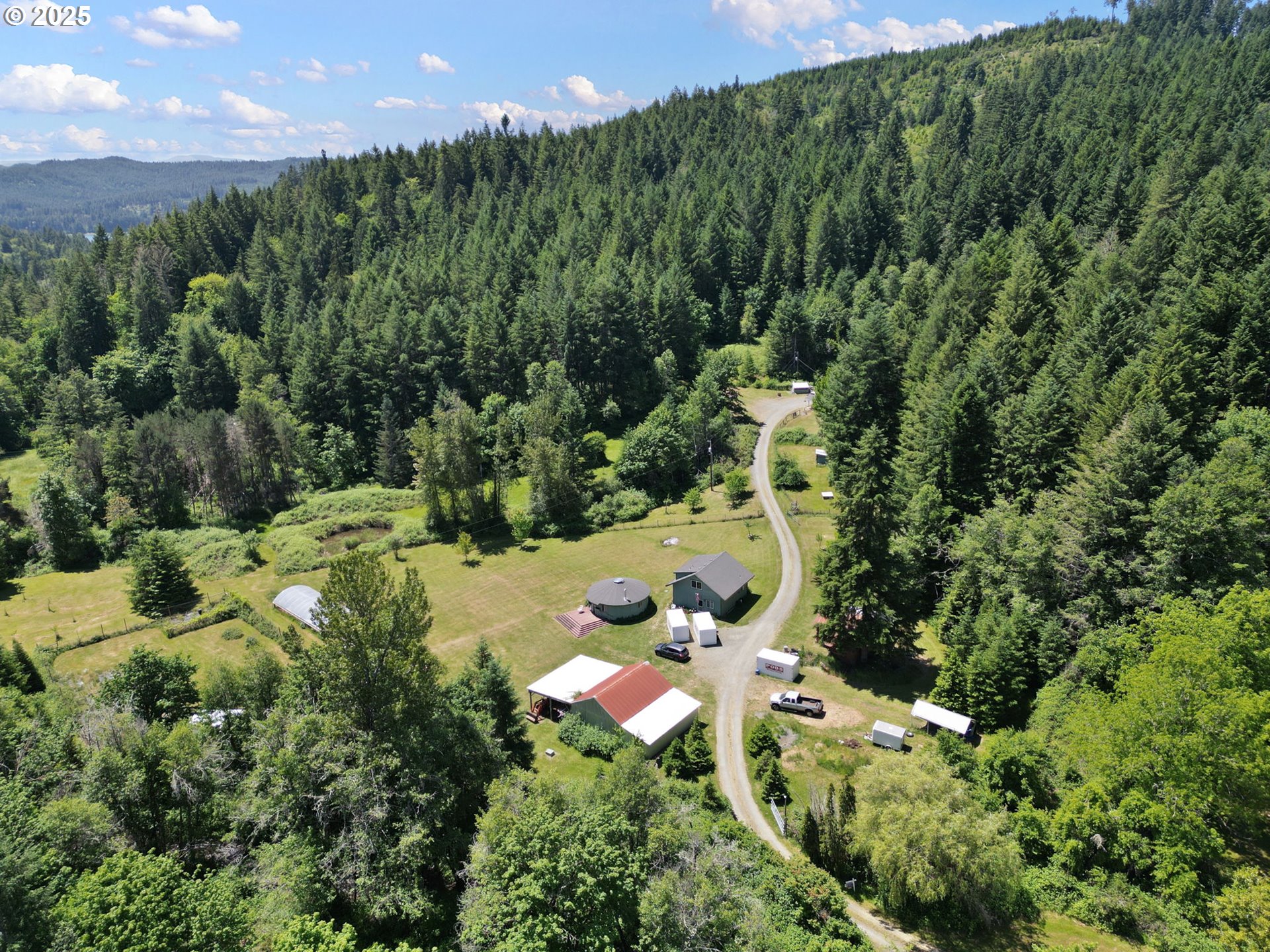 78544 Rat Creek Road Cottage Grove, OR 97424 - Photo 39 of 44 an aerial view of residential houses with outdoor space and trees all around