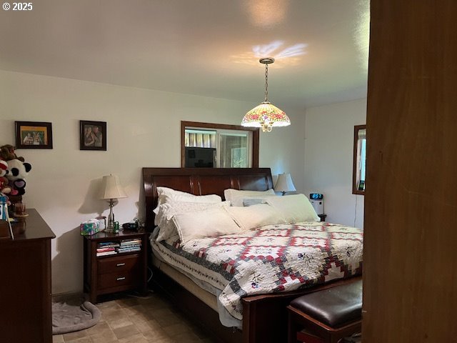 78544 Rat Creek Road Cottage Grove, OR 97424 - Photo 4 of 44 a bedroom with a bed and a chandelier