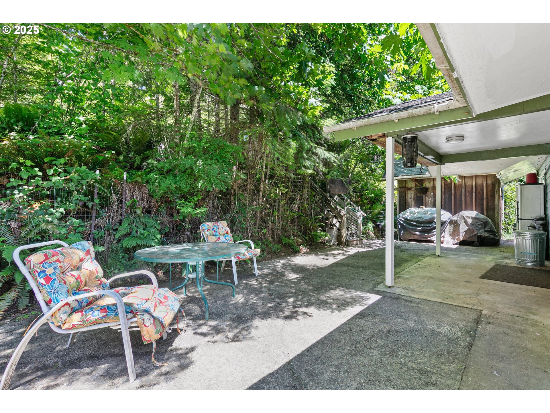 78544 Rat Creek Road Cottage Grove, OR 97424 - Photo 43 of 44 a view of a patio with a table and chairs under an umbrella