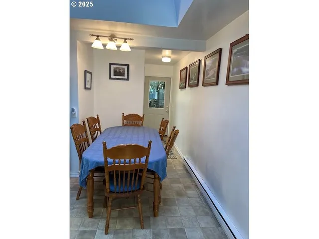 a view of a dining room with furniture and a potted plant