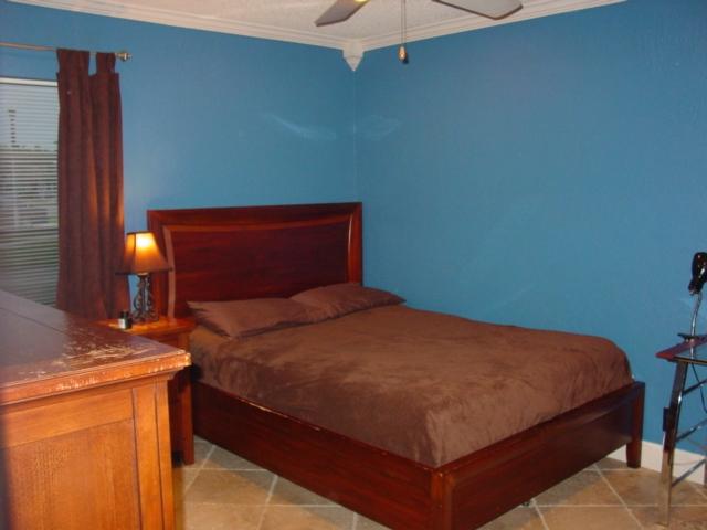 21338 Summertrace Circle Boca Raton, FL 33428 - Photo 17 of 22 a bedroom with a bed and a chandelier