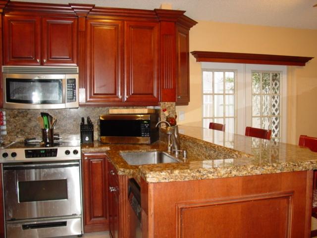 21338 Summertrace Circle Boca Raton, FL 33428 - Photo 4 of 22 a kitchen with stainless steel appliances granite countertop a stove a sink and a microwave