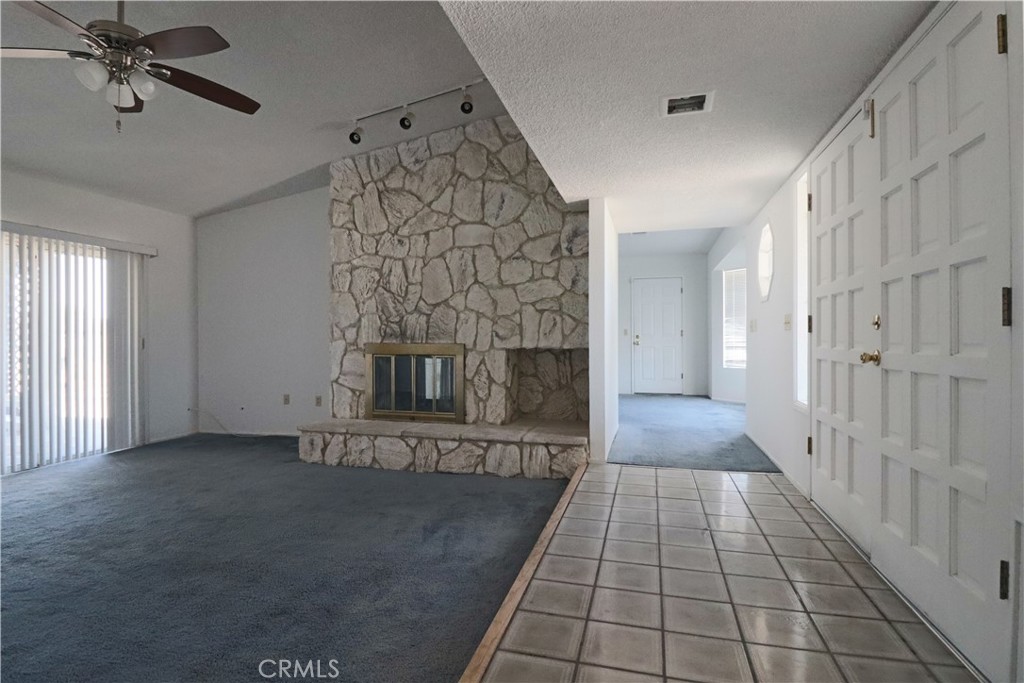 4752 Flying H Road Twentynine Palms, CA 92277 - Photo 18 of 55 a view of a livingroom with an empty space and a fireplace
