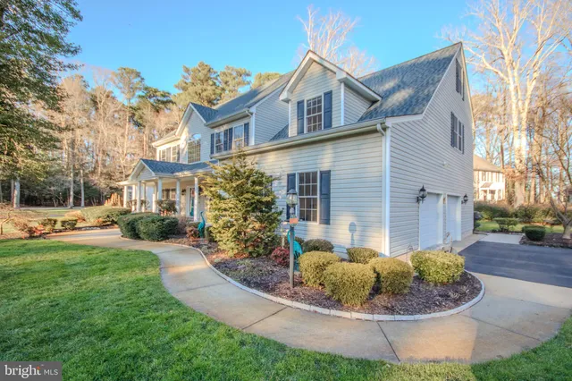 a house with lots of trees in front of it
