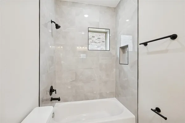 a bathroom with a bathtub and shower