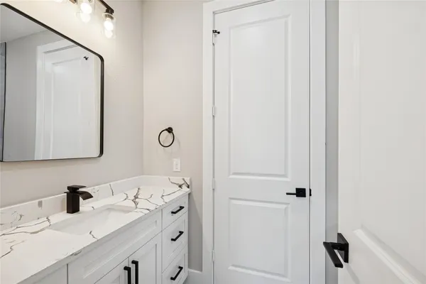 a bathroom with a sink vanity and a mirror
