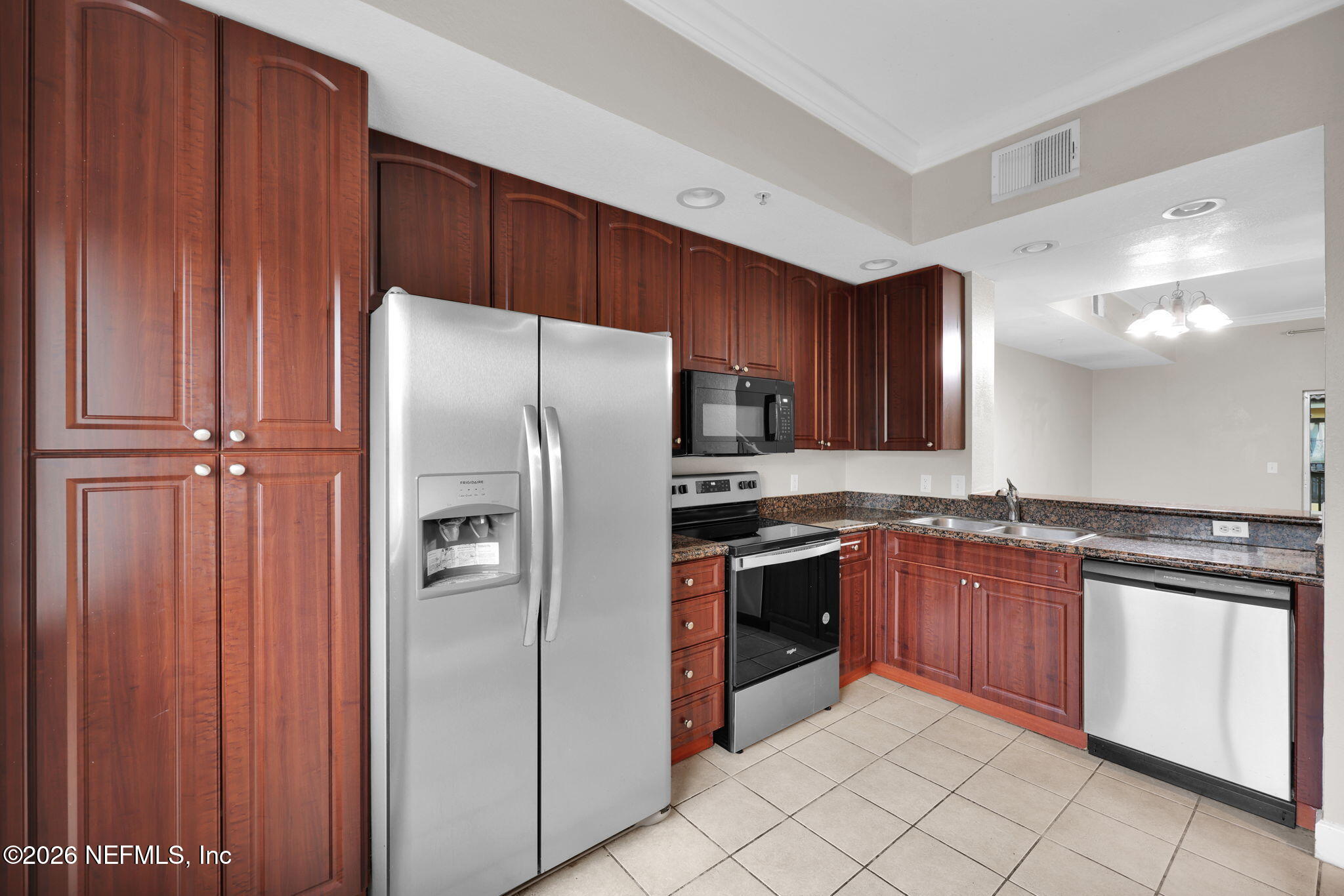 9745 Touchton Road, Unit 526 Jacksonville, FL 32246 - Photo 11 of 34 a kitchen with stainless steel appliances granite countertop a refrigerator and a sink