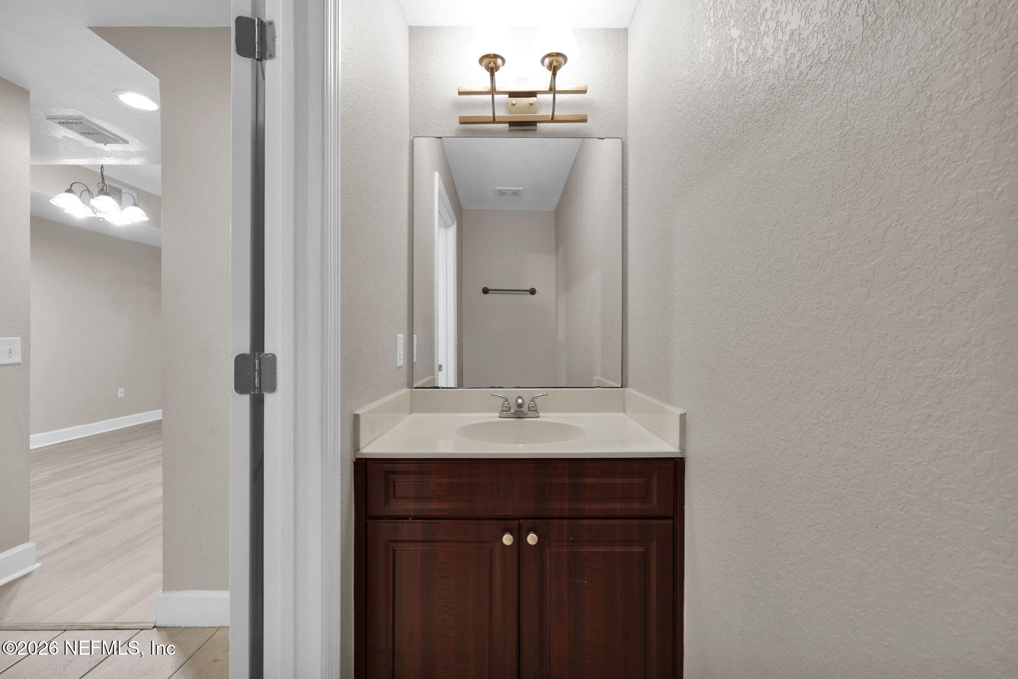 9745 Touchton Road, Unit 526 Jacksonville, FL 32246 - Photo 14 of 34 a bathroom with a sink and a mirror