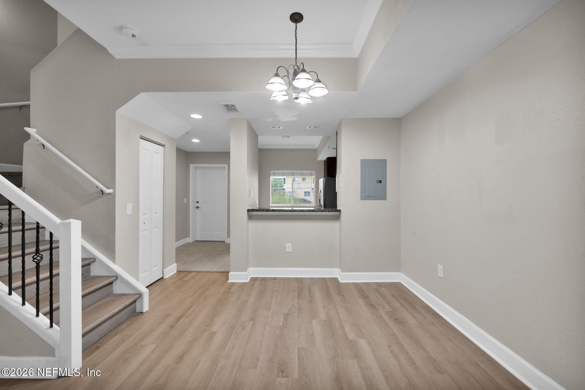 9745 Touchton Road, Unit 526 Jacksonville, FL 32246 - Photo 15 of 34 a view of an empty room with wooden floor and a kitchen