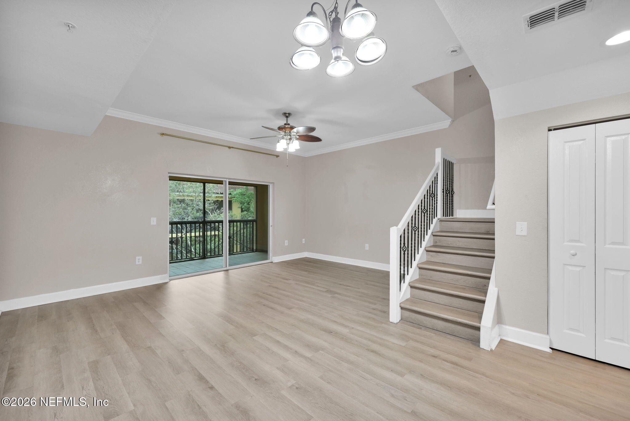 9745 Touchton Road, Unit 526 Jacksonville, FL 32246 - Photo 16 of 34 wooden floor in an empty room with a window