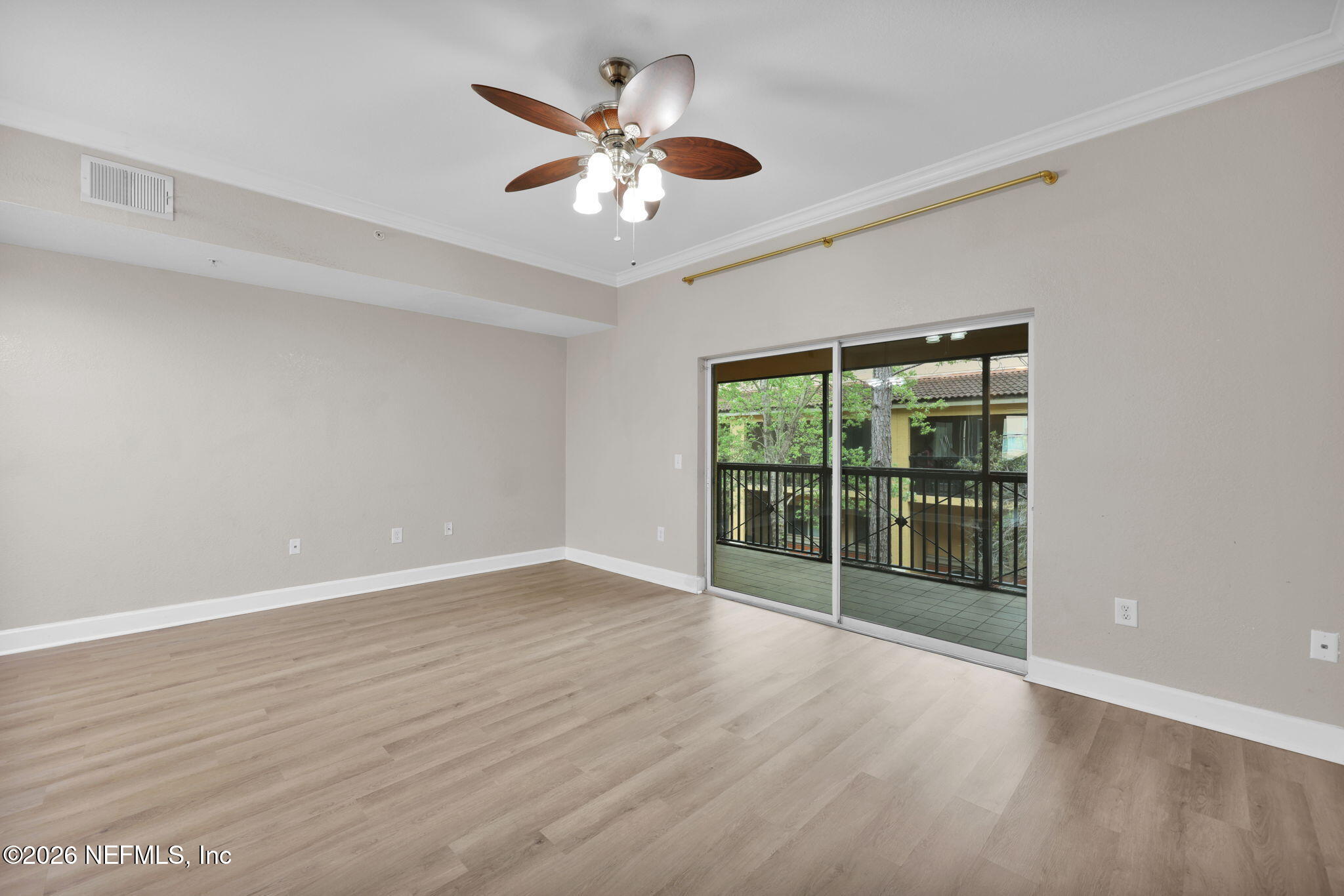 9745 Touchton Road, Unit 526 Jacksonville, FL 32246 - Photo 17 of 34 a view of an empty room with wooden floor and a window